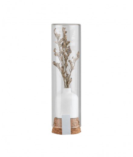 Fiole en verre contenant un soliflore en céramique et un brin de fleurs séchées.