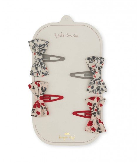 Set de 4 barrettes pour enfant avec système clic-clac et de jolis noeuds à motifs floraux. De la marque Konges Slojd